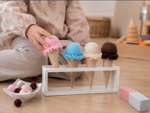 Kind spielt mit handgefertigtem Filz-Eis am Holz-Eisständer- Montessori Spielzeug für die Kindeküche.